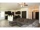 Inviting living room with dark wood floors open to the kitchen, with a ceiling fan and neutral decor at 8820 First Run Ct, Charlotte, NC 28215