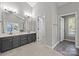 Bathroom featuring double sinks and neutral color scheme with access to a walk-in closet at 9000 Stourbridge Dr, Huntersville, NC 28078