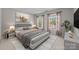 Staged bedroom features a comfortable bed, ambient lighting and tasteful decor at 9000 Stourbridge Dr, Huntersville, NC 28078