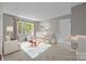 Charming staged Bedroom with crib, rocking horse, and play area, filled with natural light at 9000 Stourbridge Dr, Huntersville, NC 28078