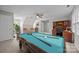 Spacious bonus room rendered with pool table, wet bar and seating near built-in desk at 9000 Stourbridge Dr, Huntersville, NC 28078