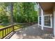 Expansive wooden deck overlooks lush, wooded backyard and mature trees at 9000 Stourbridge Dr, Huntersville, NC 28078