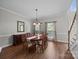 Traditional dining room with hardwood floors, a large table with seating for eight, and elegant chandelier at 9000 Stourbridge Dr, Huntersville, NC 28078