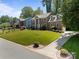 Two-story brick home with a well-maintained lawn, mature trees, and a paved driveway at 9000 Stourbridge Dr, Huntersville, NC 28078