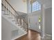 Entryway with hardwood floors, staircase, a large window above the front door providing natural light at 9000 Stourbridge Dr, Huntersville, NC 28078