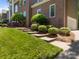 Landscaped front yard with green lawn and various shrubbery and concrete stairs leading up to the house at 9000 Stourbridge Dr, Huntersville, NC 28078