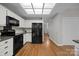 Kitchen boasting sleek, black appliances, and light wood floors at 9000 Stourbridge Dr, Huntersville, NC 28078