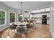 Bright kitchen with white cabinets and a center island, adjacent to a dining area with a round table at 9000 Stourbridge Dr, Huntersville, NC 28078