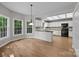 Bright eat-in kitchen featuring white cabinets, hardwood floors, a skylight and natural light from large windows at 9000 Stourbridge Dr, Huntersville, NC 28078