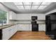 Kitchen showcasing white cabinets, stainless steel sink and black appliances at 9000 Stourbridge Dr, Huntersville, NC 28078