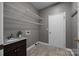 Laundry room with white shelving and a dark wood cabinet sink at 9000 Stourbridge Dr, Huntersville, NC 28078