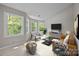 Inviting living room featuring bright light from large windows, modern decor, and comfortable seating at 9000 Stourbridge Dr, Huntersville, NC 28078