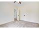 Bedroom with carpet, ceiling fan, and a door to an adjoining bathroom at 9165 Cherokee Dr, Hickory, NC 28601