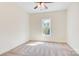 Bright bedroom with neutral carpet, ceiling fan, and a window providing natural light at 9165 Cherokee Dr, Hickory, NC 28601
