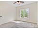 Bedroom featuring neutral carpet, a window and a ceiling fan at 9165 Cherokee Dr, Hickory, NC 28601