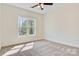 Bedroom featuring neutral carpet, a window and a ceiling fan at 9165 Cherokee Dr, Hickory, NC 28601