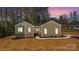 A single-story home showcasing a well-maintained lawn, fresh landscaping, and a charming entryway at 9165 Cherokee Dr, Hickory, NC 28601