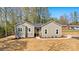 A single-story house with a freshly seeded lawn, landscaping, and natural surroundings at 9165 Cherokee Dr, Hickory, NC 28601