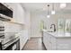 Open kitchen featuring white cabinetry, stainless steel appliances, granite counters, and a kitchen island at 9165 Cherokee Dr, Hickory, NC 28601