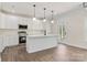 Bright kitchen featuring white cabinets, stainless steel appliances, an island, and wood-look flooring at 9165 Cherokee Dr, Hickory, NC 28601