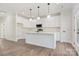 Modern kitchen with white cabinetry, quartz countertops, stainless steel appliances, and a center island at 9165 Cherokee Dr, Hickory, NC 28601