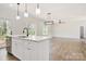 Open concept kitchen featuring white countertops, stainless steel appliances, and wood-look flooring at 9165 Cherokee Dr, Hickory, NC 28601