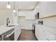 Well-lit kitchen boasts white cabinetry, stainless appliances, a subway tile backsplash, and wood-look floors at 9165 Cherokee Dr, Hickory, NC 28601