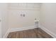Laundry room with wood-look flooring and utility connections at 9165 Cherokee Dr, Hickory, NC 28601