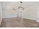 Spacious living room with hardwood floors, neutral walls, modern lighting, and a ceiling fan at 9165 Cherokee Dr, Hickory, NC 28601