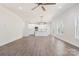 Open concept living area with hardwood floors, a ceiling fan, and a view of the modern kitchen at 9165 Cherokee Dr, Hickory, NC 28601