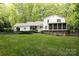 Large, landscaped backyard with a well-maintained lawn, trees, and patio at 9439 White Hemlock Ln, Charlotte, NC 28270