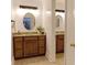 Bathroom with double vanity, wood cabinets, granite counters, and modern lighting fixtures at 9439 White Hemlock Ln, Charlotte, NC 28270