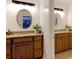 Dual vanity bathroom with wood cabinets, granite countertops, and modern lighting at 9439 White Hemlock Ln, Charlotte, NC 28270