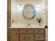 Updated bathroom vanity with decorative lighting and stylish mirror at 9439 White Hemlock Ln, Charlotte, NC 28270