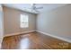 Empty bedroom featuring hardwood floors, a ceiling fan, and natural light at 9439 White Hemlock Ln, Charlotte, NC 28270