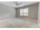 Empty bedroom featuring neutral carpet, a ceiling fan, and natural light at 9439 White Hemlock Ln, Charlotte, NC 28270
