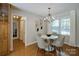 Charming dining area with hardwood floors, stylish light fixture, and seating for four at 9439 White Hemlock Ln, Charlotte, NC 28270