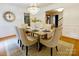Stylish dining area with hardwood floors, decorative clock, and seating for six at 9439 White Hemlock Ln, Charlotte, NC 28270