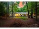 Charming home with lush greenery, mature trees, and a well-maintained lawn at 9439 White Hemlock Ln, Charlotte, NC 28270