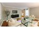 Comfortable living room showcasing hardwood floors, a modern TV, and decorative plant at 9439 White Hemlock Ln, Charlotte, NC 28270