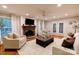 Comfortable living room featuring a fireplace, cozy seating, and natural light at 9439 White Hemlock Ln, Charlotte, NC 28270
