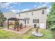 Backyard with patio, pergola, grill and lush landscaping surrounding the perimeter at 9803 Forest Run Ln, Charlotte, NC 28277