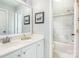 Bright bathroom featuring double sinks, vanity, and shower with glass doors at 9803 Forest Run Ln, Charlotte, NC 28277