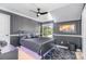 Modern bedroom featuring modern dark gray walls and a ceiling fan at 9803 Forest Run Ln, Charlotte, NC 28277