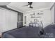 Modern bedroom featuring dark gray walls and a ceiling fan at 9803 Forest Run Ln, Charlotte, NC 28277