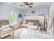 Bedroom features cozy seating, decor, a window, and a white accent wall above the futon at 9803 Forest Run Ln, Charlotte, NC 28277