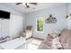 Bright bedroom features a futon, an accent chair, and a large window with natural light at 9803 Forest Run Ln, Charlotte, NC 28277