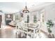 Bright dining area featuring a stylish chandelier, hardwood floors, and ample natural light at 9803 Forest Run Ln, Charlotte, NC 28277
