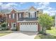 Charming two-story brick home featuring a two-car garage and professionally landscaped front yard at 9803 Forest Run Ln, Charlotte, NC 28277