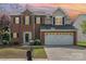 Charming two-story brick home featuring a two-car garage and professionally landscaped front yard at 9803 Forest Run Ln, Charlotte, NC 28277